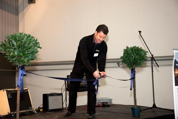 Fletcher Aluminium Franchisee Spokesman, Tom Foster cuts the ribbon at the new factory in Christchurch